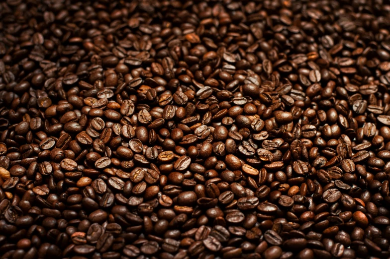 a mixture of coffee beans scattered on top of each other