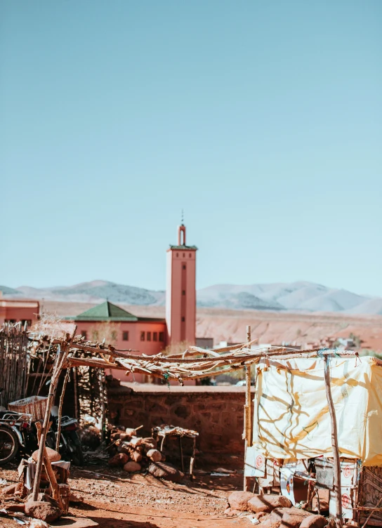 a view of a small building with a clock tower in the background