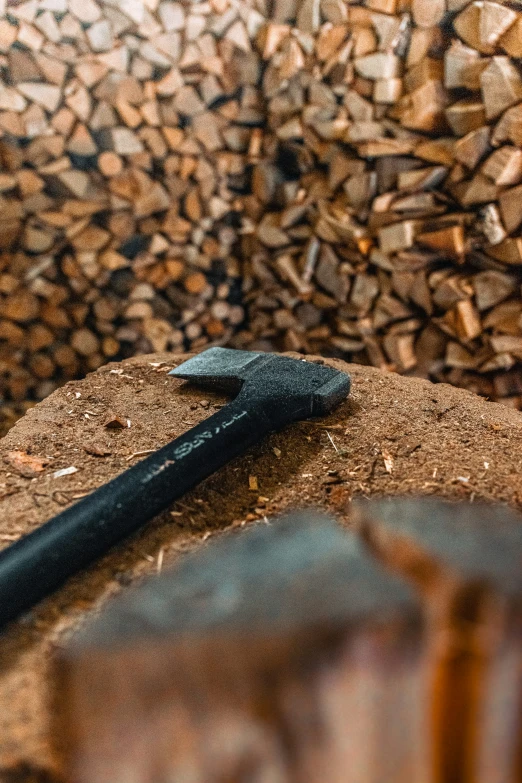 a razor blade is lying on top of a pile of fire wood