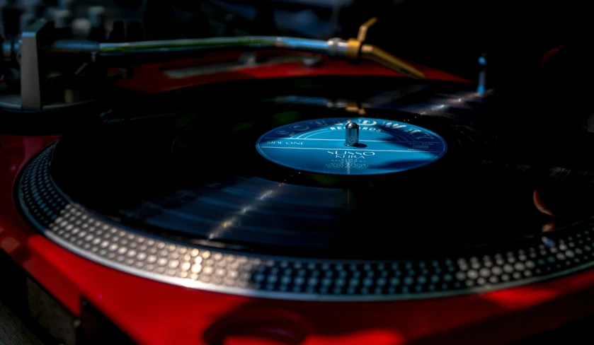 a red turntable with two decks sitting on top of it