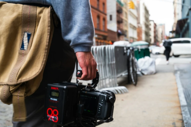 a man is holding a video camera