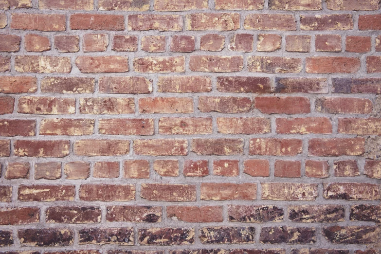a brick wall with an odd shaped stain on the side