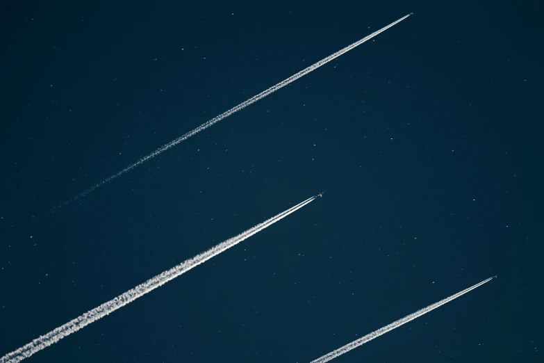two airplane trails going in different directions