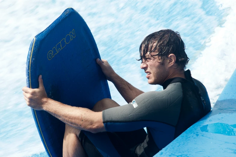 a surfer sitting in the water with his surf board