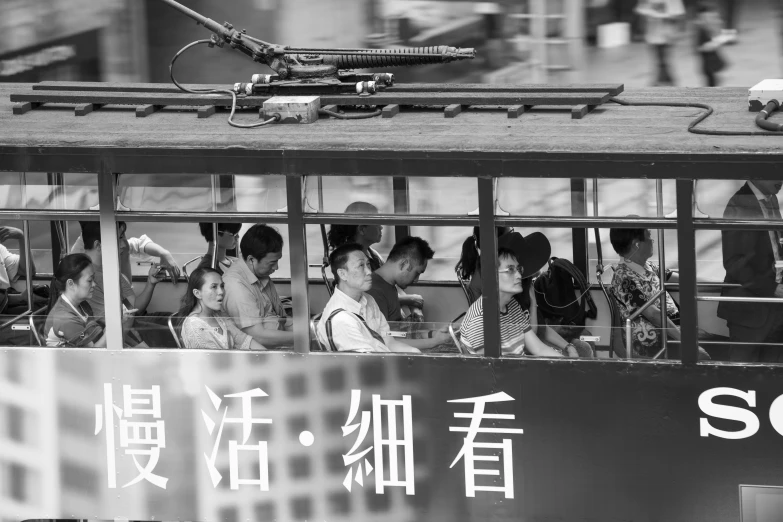 a small group of people are sitting inside of a passenger bus