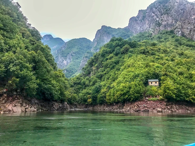 a boat in a river and some mountains