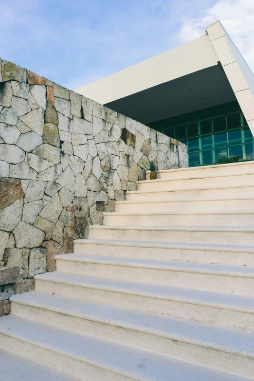 the steps have stone walls on them and a door in front