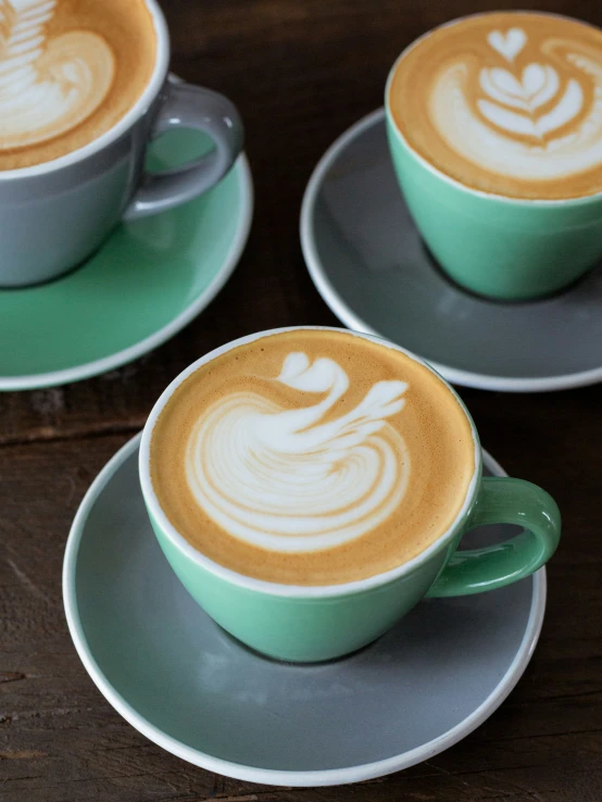 coffee cups with artfully designed foams on them