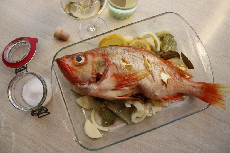 a red fish on a bed of pasta and vegetables