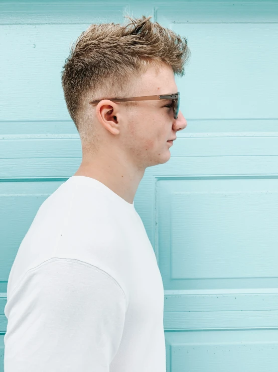 a man with a spiked haircut, wearing sunglasses