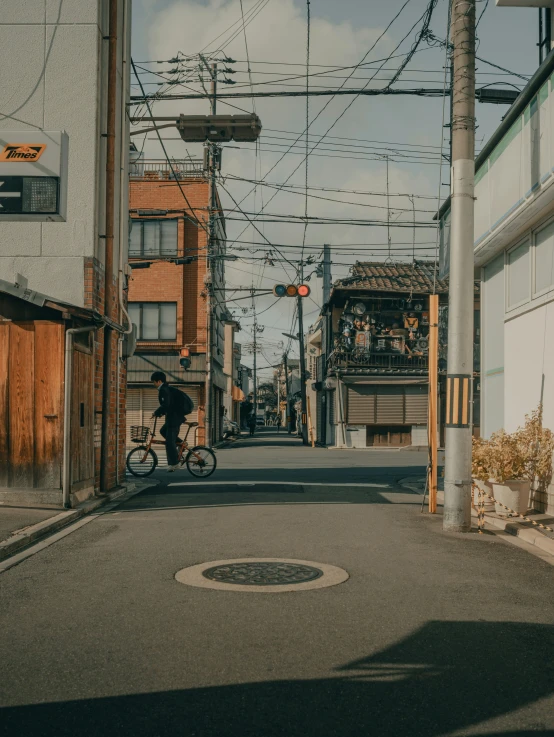 person riding a bicycle on an empty street