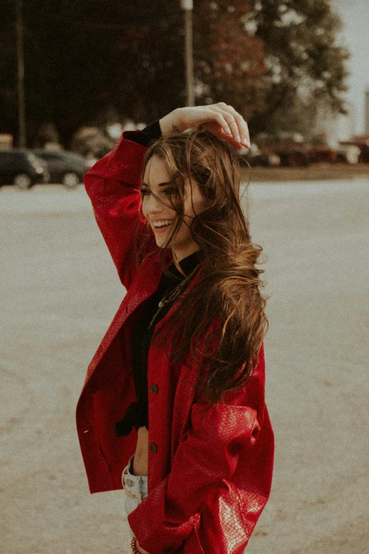 a woman in red jacket on a concrete road