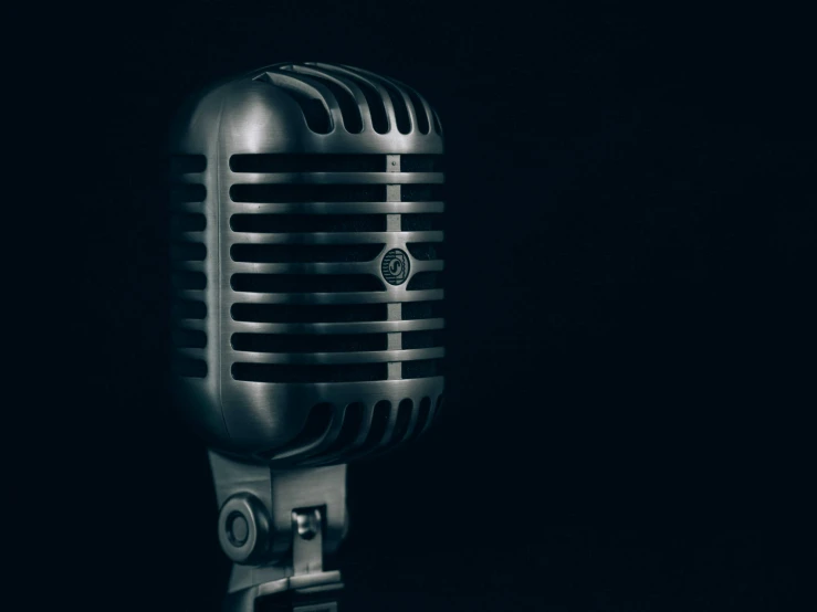 an antique - style microphone is placed in front of a black background