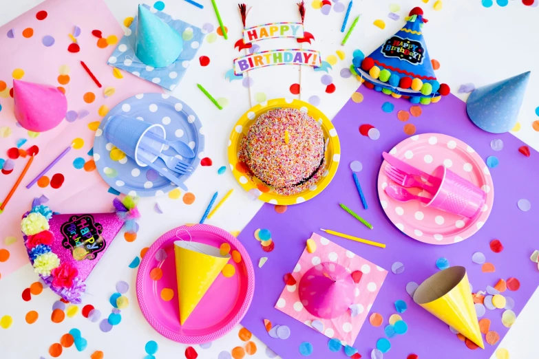 a table with party supplies and decorations for a birthday