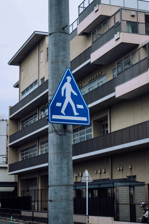 a pedestrian crossing sign in a city square