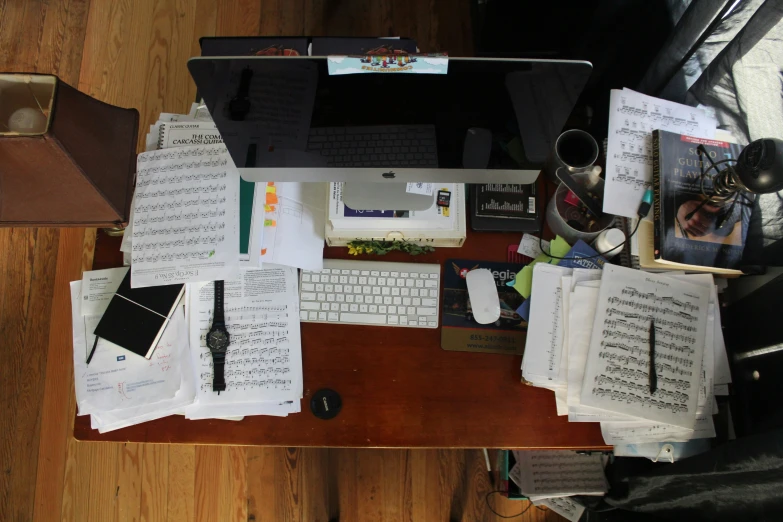 a table topped with lots of papers and music notes