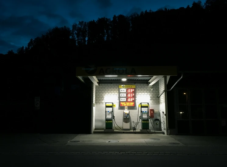 a gas pump at night under some dark clouds