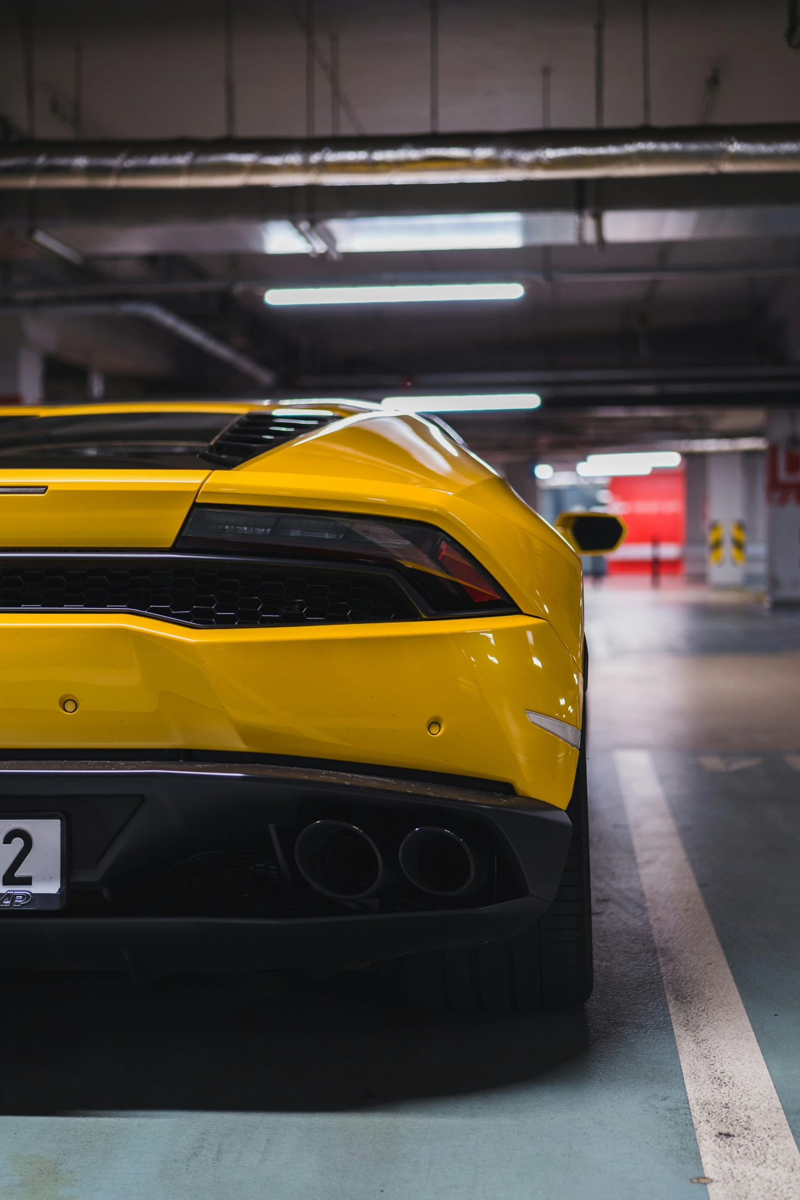 the rear of a sports car parked inside a garage