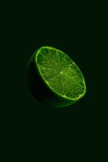 a lime has been cut in half, on a dark green background
