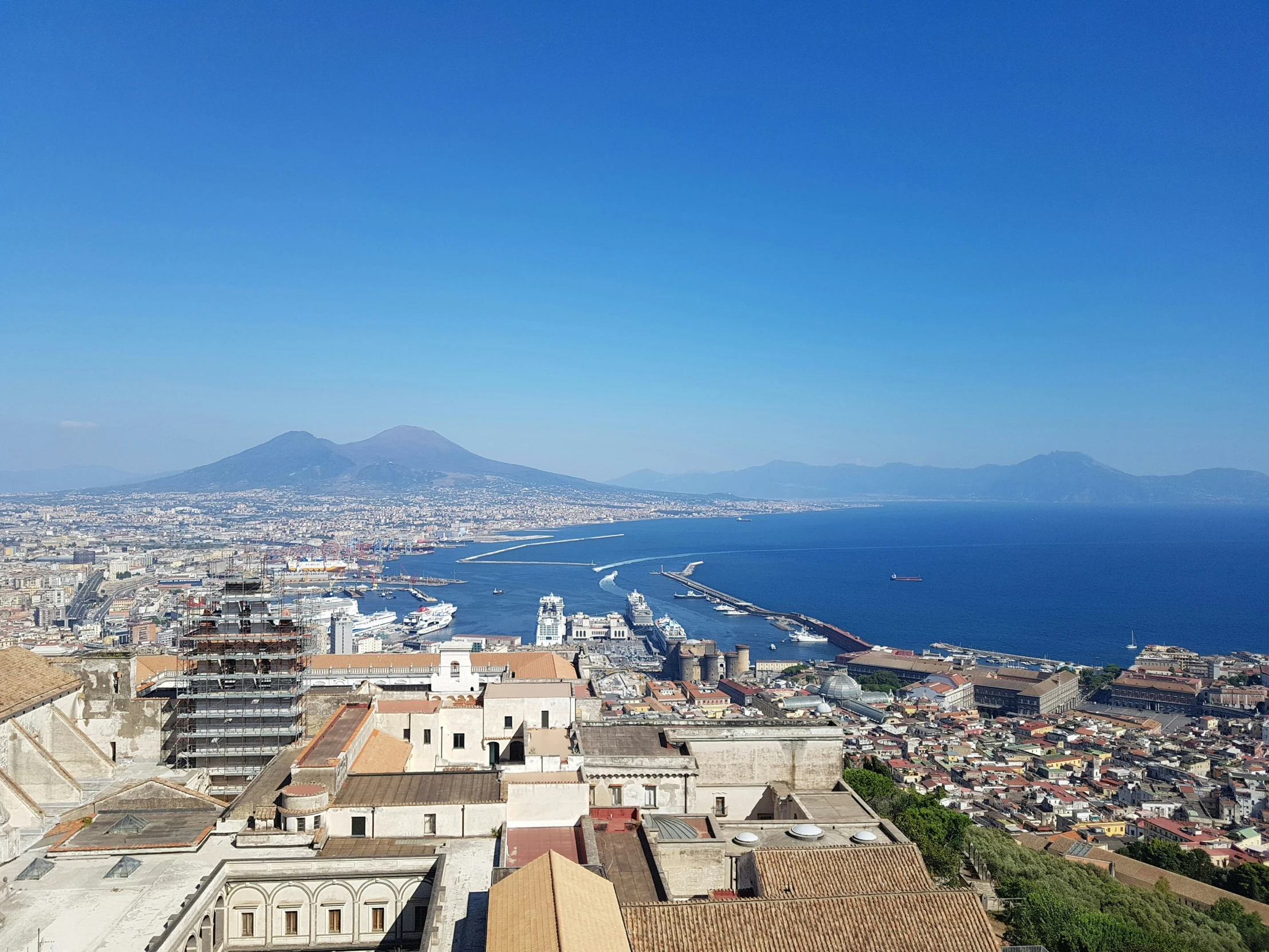 a beautiful view of a city with water and mountains in the distance