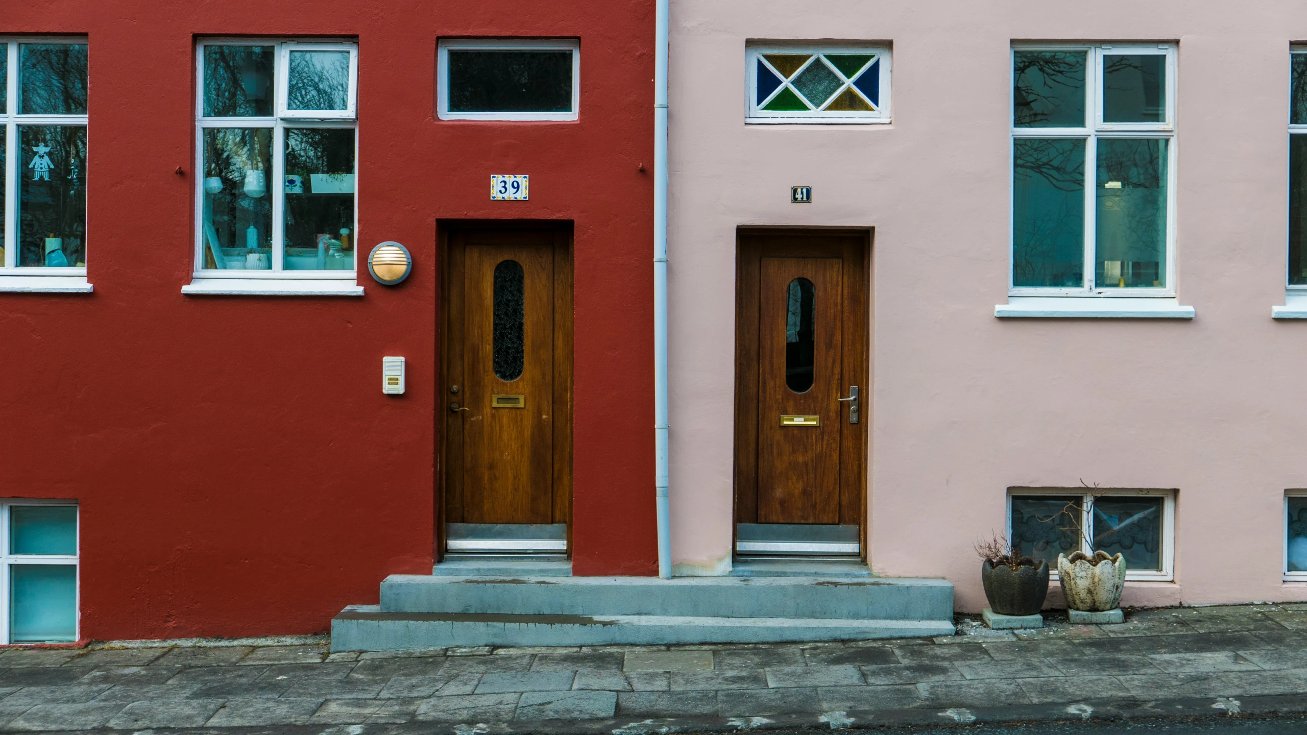 two buildings with two doors and window frames