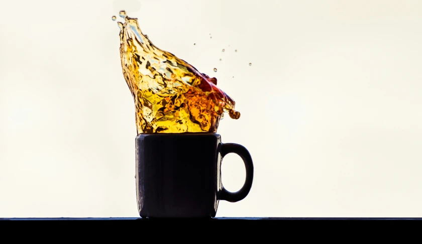 an unusual looking liquid on a coffee cup