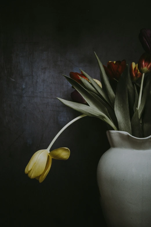 flowers are in a white vase on a table