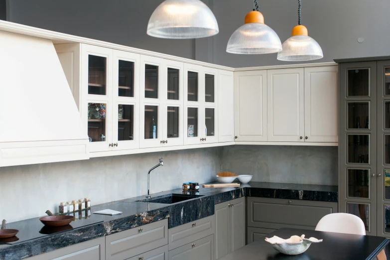 the kitchen has three hanging lights over the counter