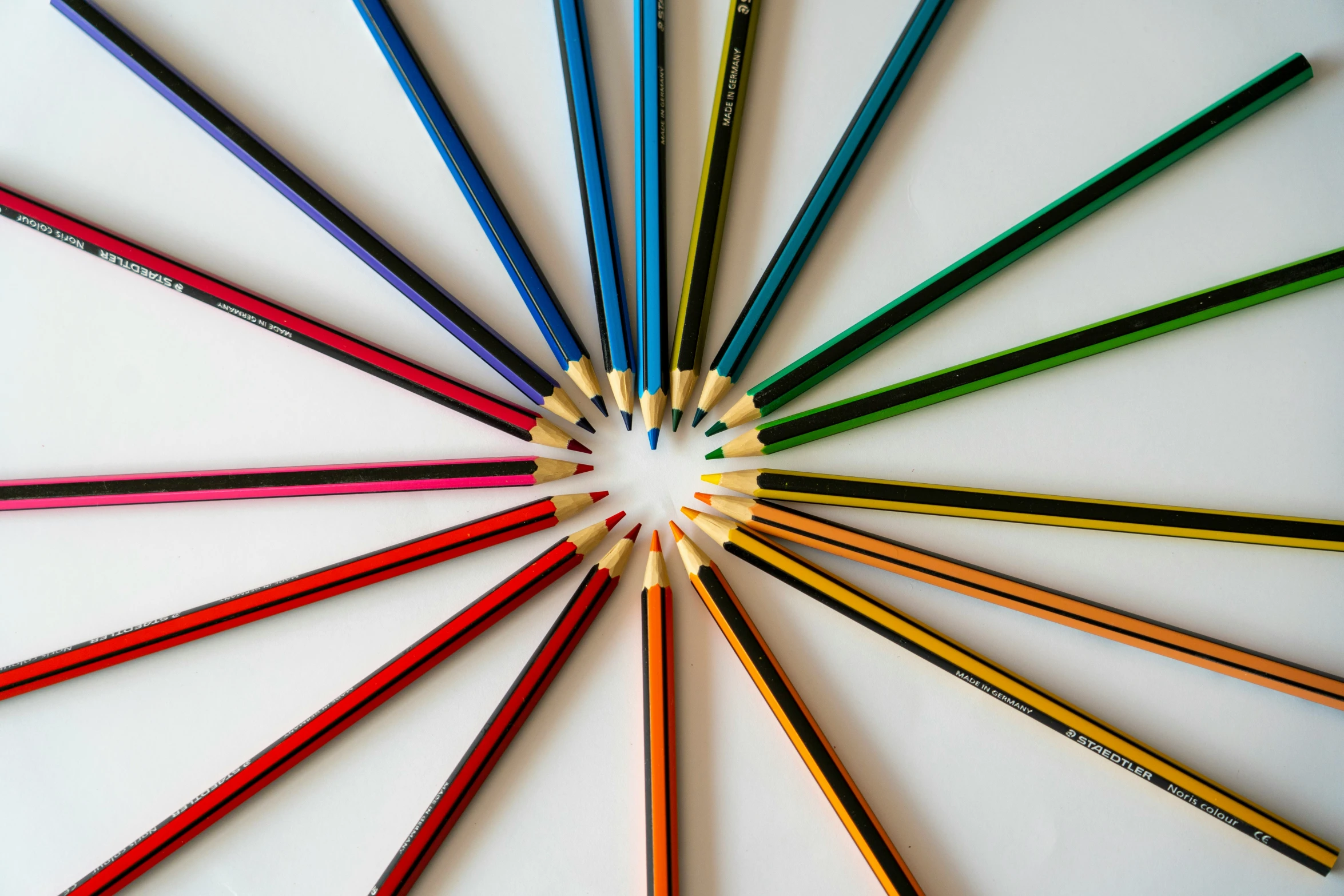 several colored pencils arranged in a circle