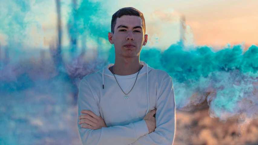 a man stands in front of colorful smoke