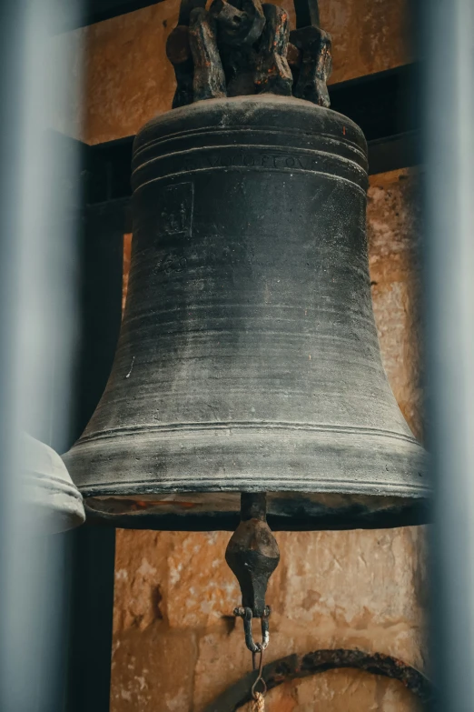 a bell with chains is hanging from the wall