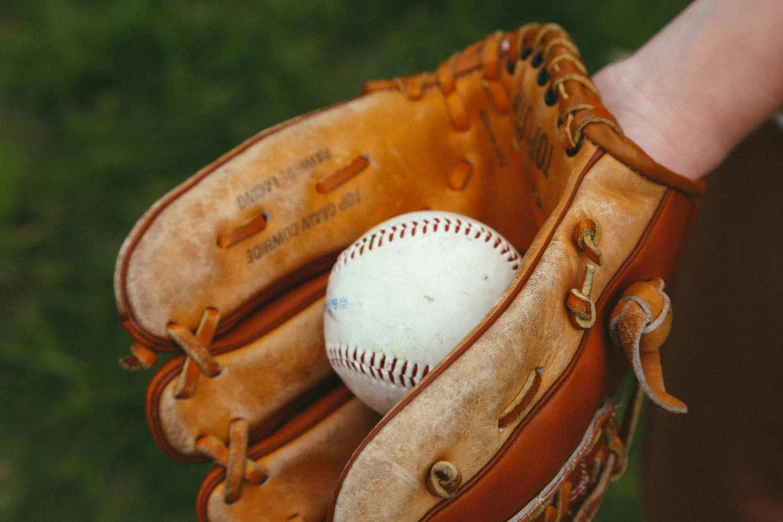 the ball inside the glove is on top of the mitt