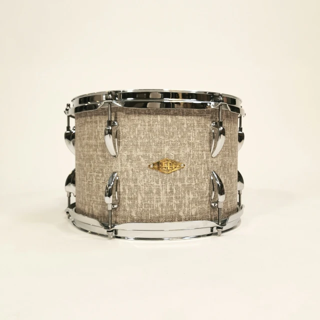 the side of a snare drum with silver hardware