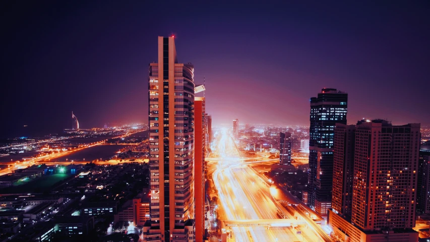 a city street filled with traffic under high rise buildings