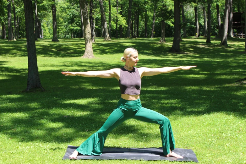 a young woman practicing yoga outside on her stomach
