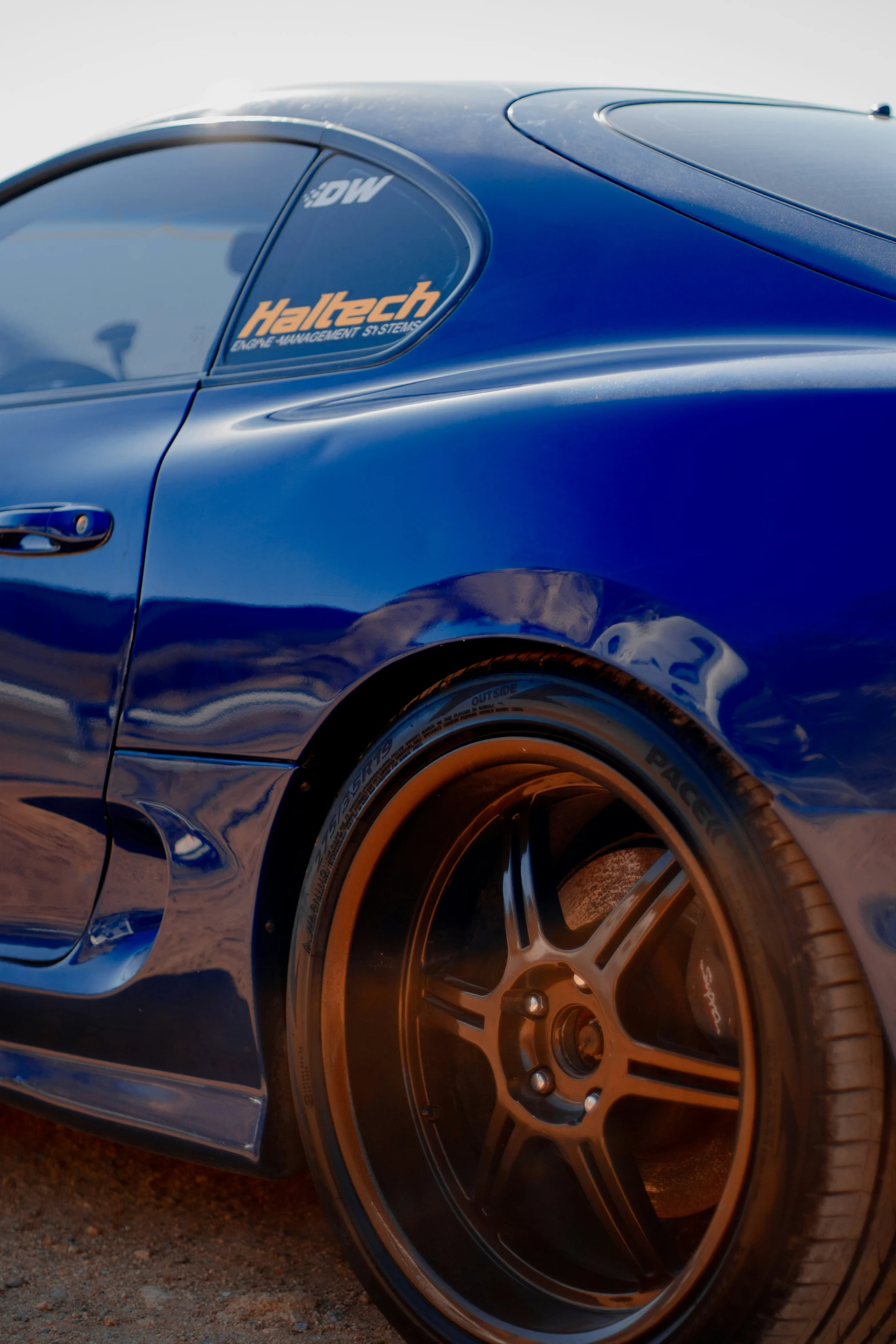 a blue car with the word harttech on it is parked in a parking lot