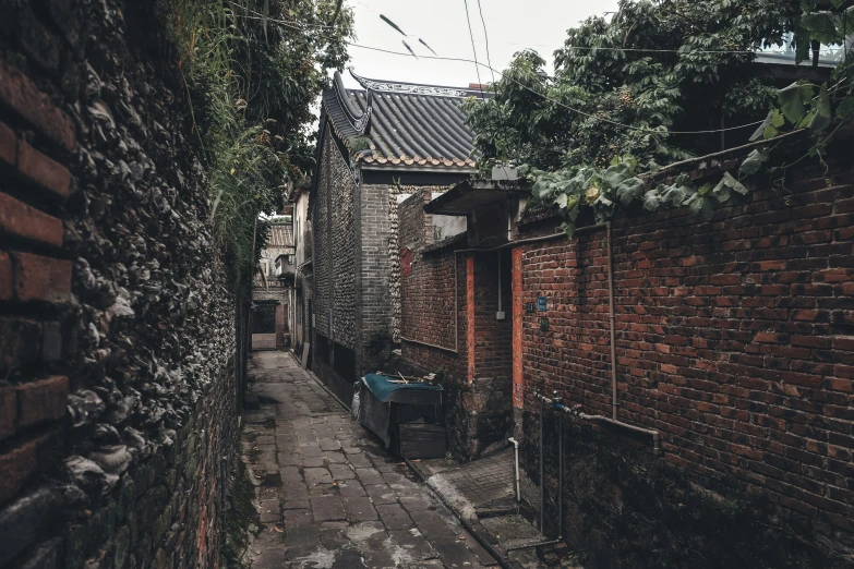 an alleyway with a table and chair between two buildings