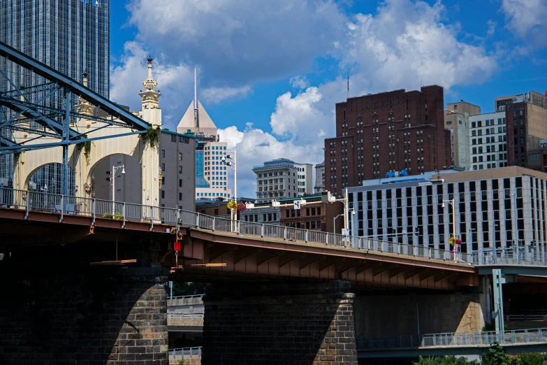 a bridge with tall buildings surrounding it in the city