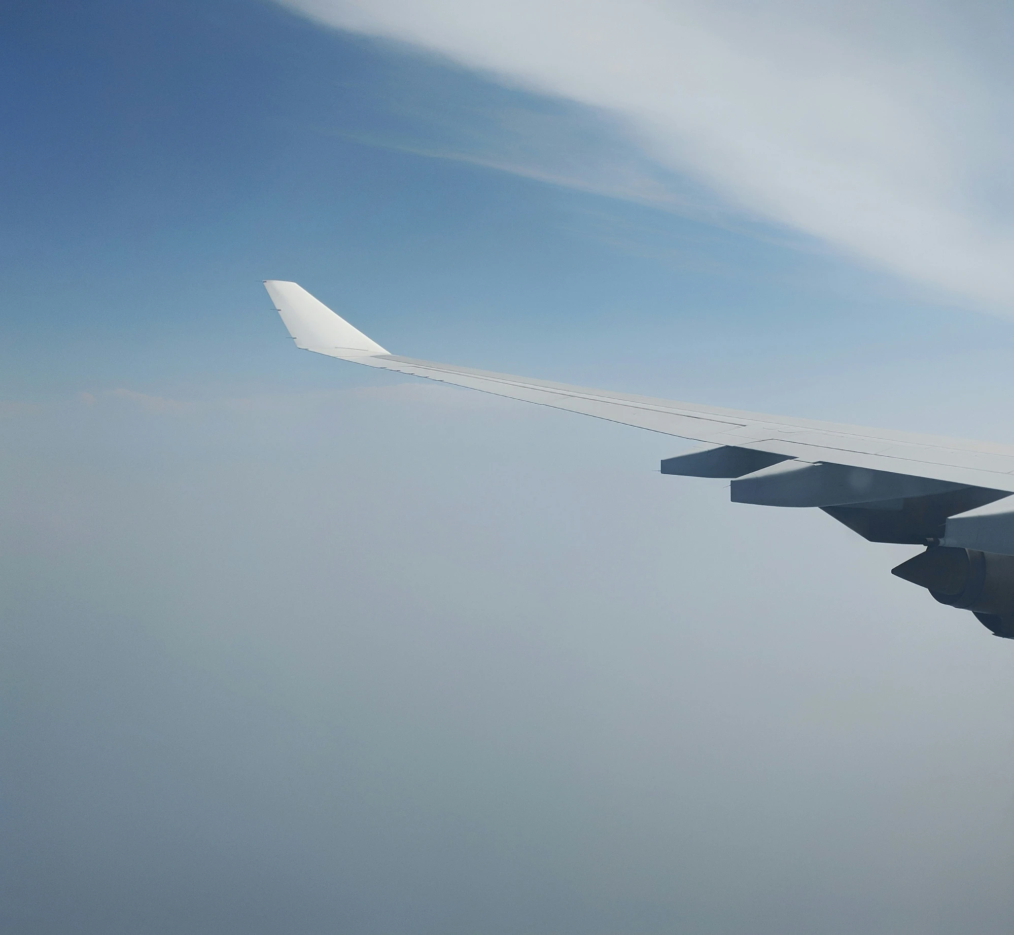 a view of an airplane wing and sky