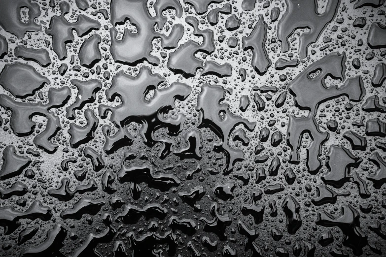 some water drops sitting on top of a wet window