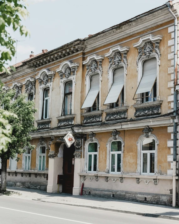 a large building with multiple windows, ornate designs and trim