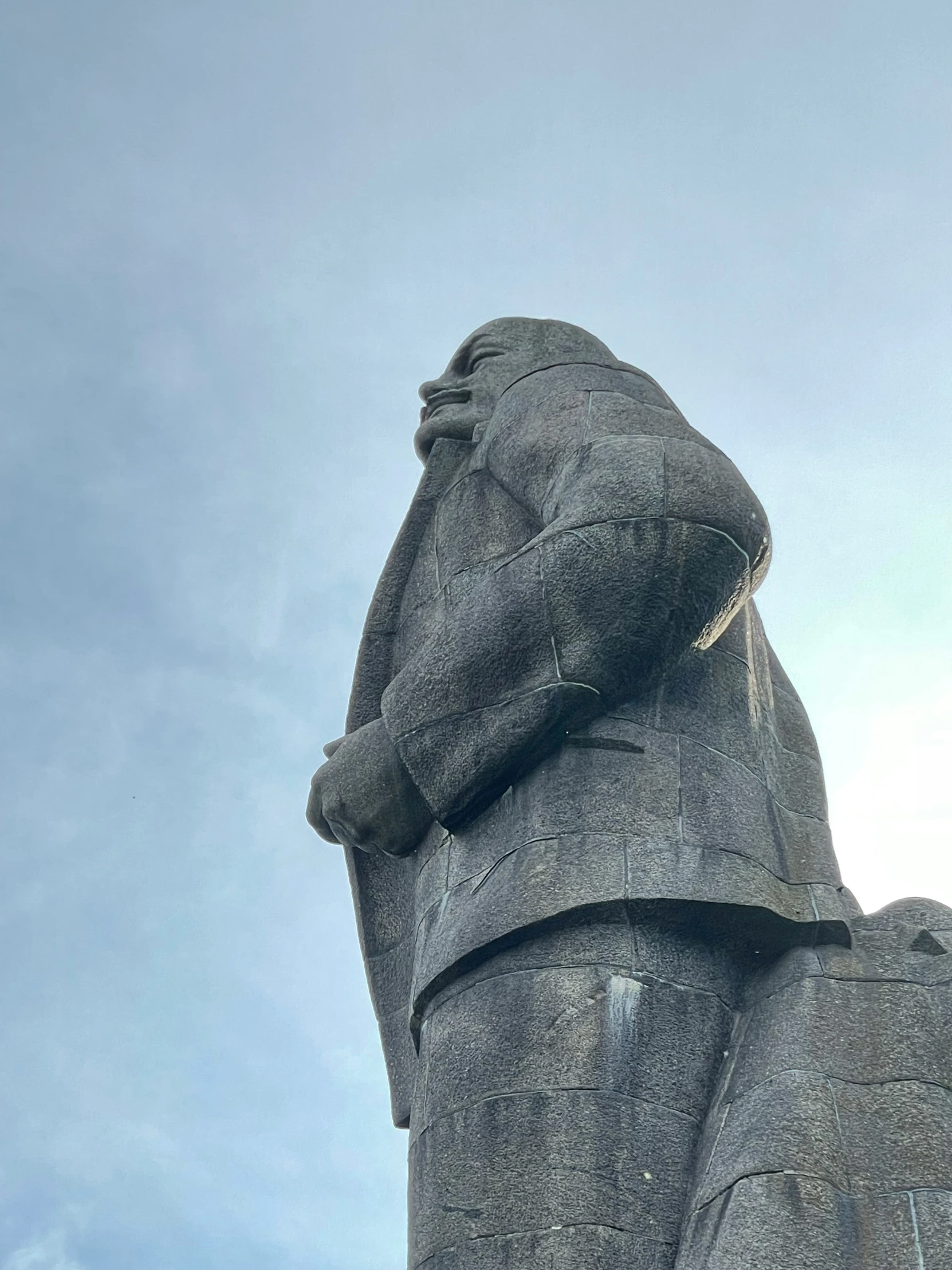 the large bear statue has his paws stretched out