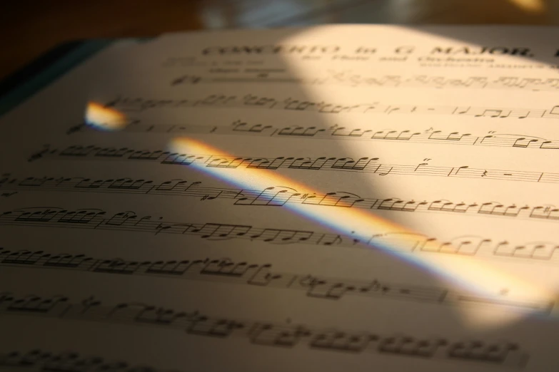 sheet music, from the side with sun reflecting on it