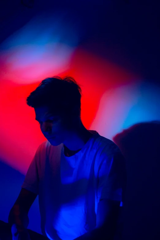 a man with an open laptop in a dark room