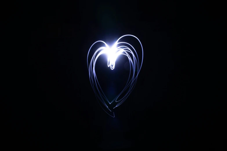 a heart shaped light being pographed with long exposure