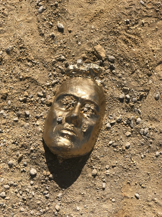 a face is carved in the dirt