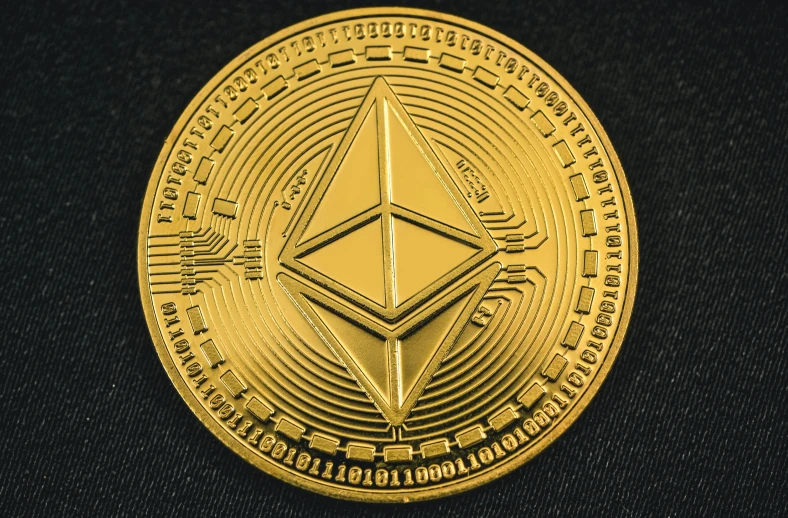 a gold medallion with an image of the ether ether symbol