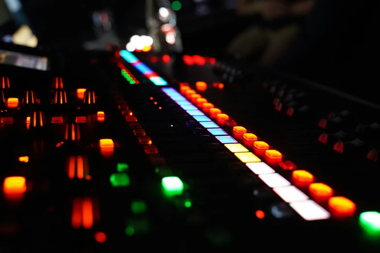 the sound board is full of orange and green lights