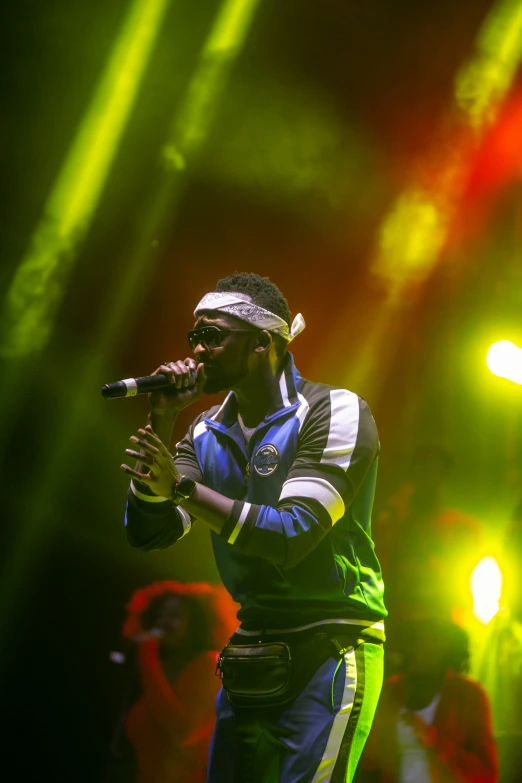 a man standing on top of a stage holding a microphone