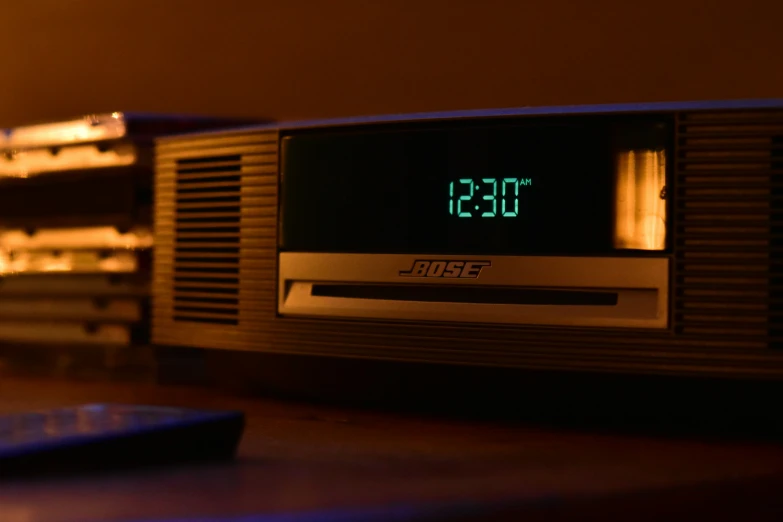 an analog clock radio is lit up by the night